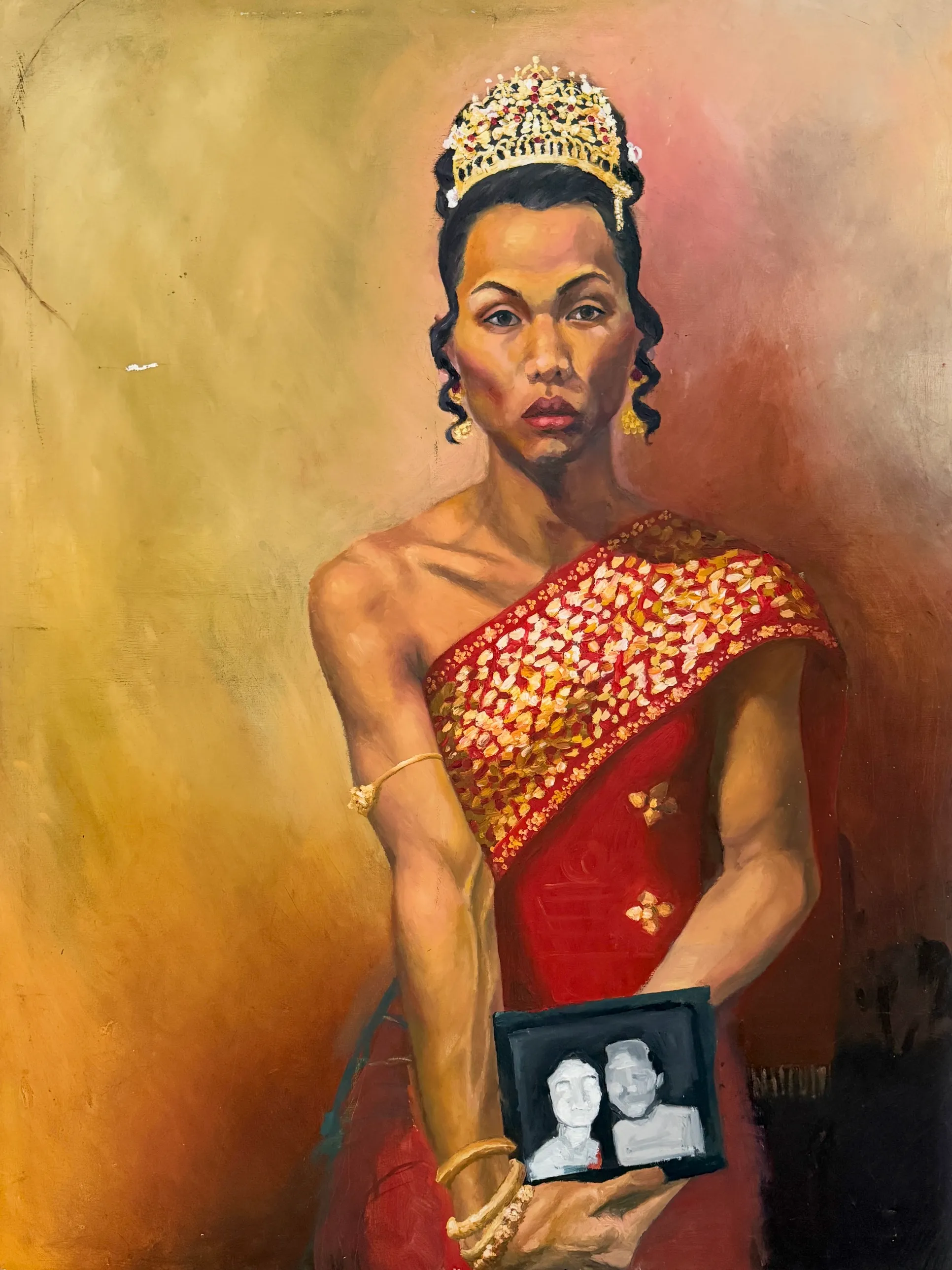 An oil portrait — a figure in a gold crown and a red sash embroidered with gold, holding a small framed photograph of two faces