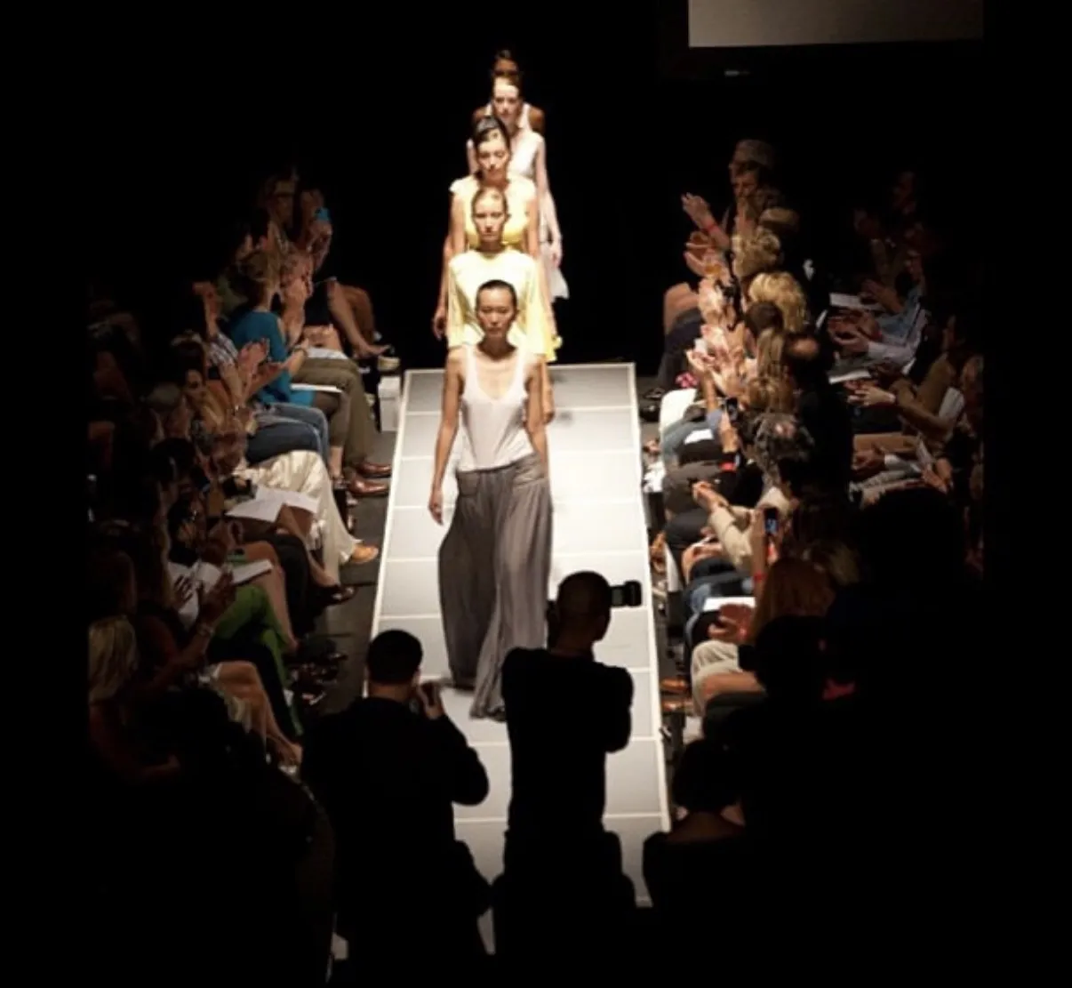 The Selahdor finale — models in white, yellow and grey walking the runway in single file